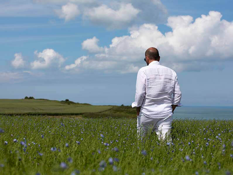 Mr. Antonino Aiello in a flied of flax flowers 100% Capri Sustainability, Linen Clothing 