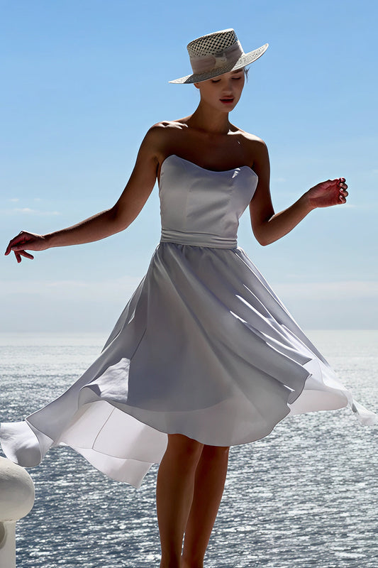 Model wearing white Marilyn dress – 100% Capri