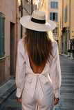Back view of model wearing Fabi white linen shirt with open-back tie detail – 100% Capri
