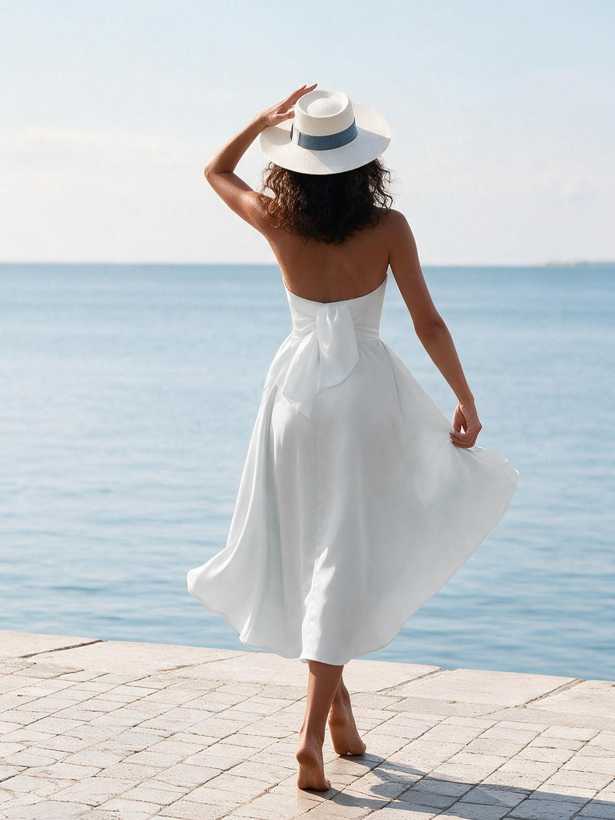 Model wearing Marilyn white linen dress, back view – 100% Capri